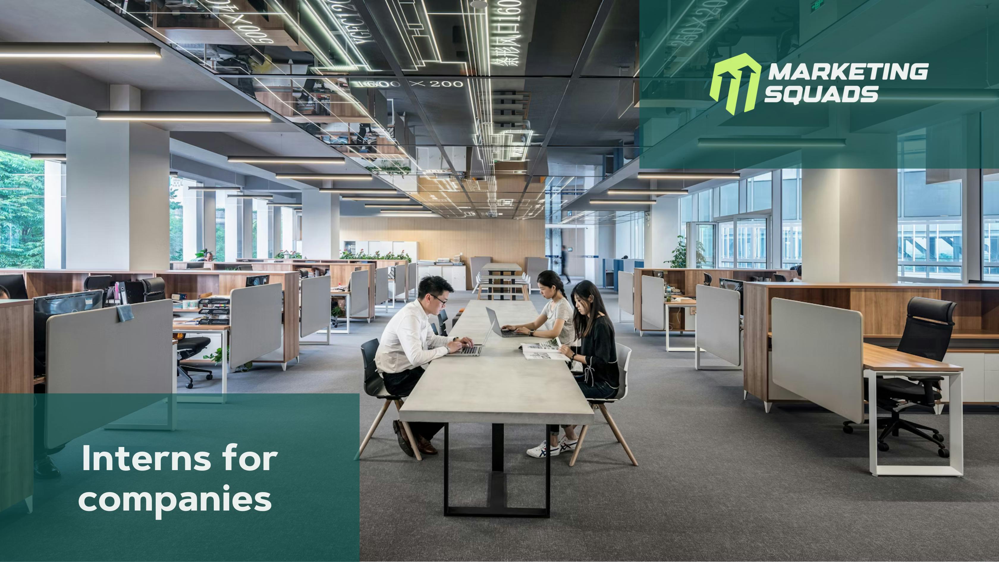 Big office with 3 people working at a white desk